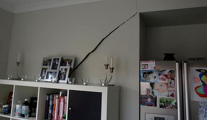 Jayme Mylan shows a crack inside her Brookfield house - Realestateads.com.au